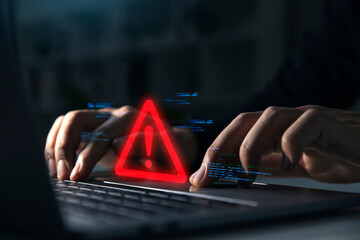 Hand of businessman using laptop with caution warning sign for notification error and maintenance...