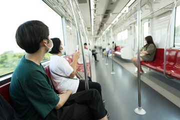 Asian young boy sitting on the chair  in the train.Public transport concept.