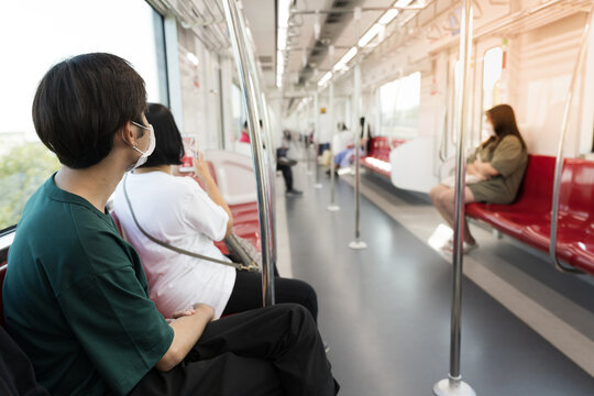 Asian young boy sitting on the chair  in the train.Public transport concept. - Powered by Adobe