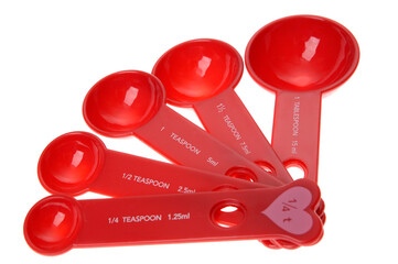 Set of red measuring spoons, fanned out
