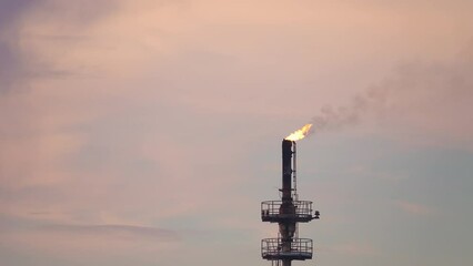 Footage B Roll A Fire on flare stack at refinery oil and gas central processing platform while burning toxic and release over pressure. gas flare at an oil refinery factory industrial. footage b roll.