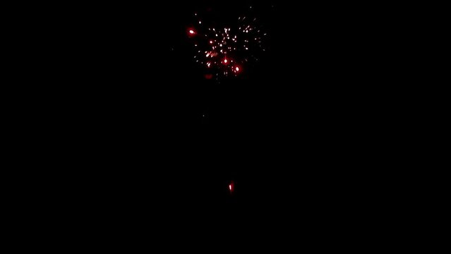 Explosion of bright colorful part of fireworks on black background to create a set salute on video for holiday new year, birthday, wedding or other celebration.
