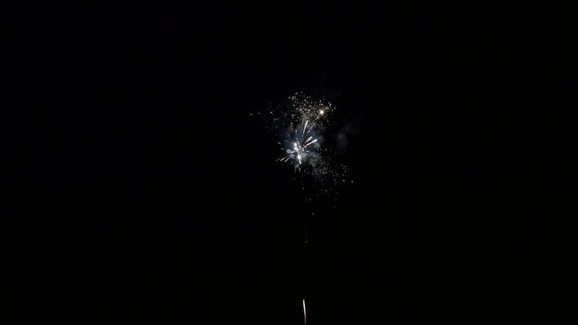 Explosion of bright colorful part of fireworks on black background to create a set salute on video for holiday new year, birthday, wedding or other celebration.