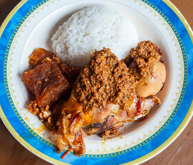 Nasi Gudeg. Traditional Javanese meal of young jack fruit stew accompanied with spicy cattle skin cracker stew and chicken curry.