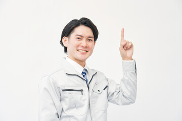 上を指差す作業着の男性　白背景