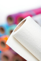 Multicolored soft felt textile material, fabric texture in rolls closeup