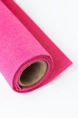 Soft felt textile material of pink color, colorful texture fabric roll close-up