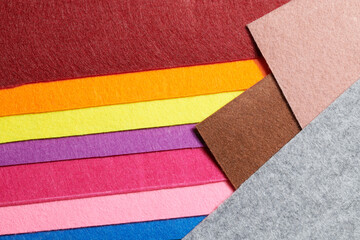 Multi-colored soft felt textile material, colorful patchwork texture fabric close-up