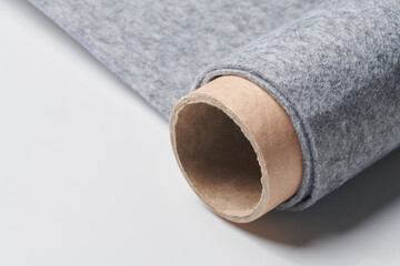Soft felt textile material gray color, colorful texture fabric roll closeup