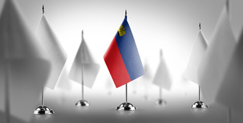 The national flag of the Liechtenstein surrounded by white flags