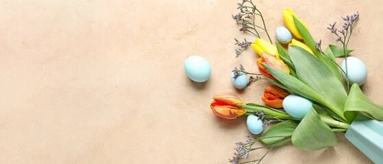 Beautiful flowers and painted Easter eggs on beige background with space for text