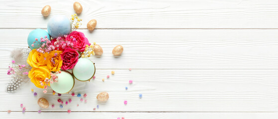 Beautiful composition with Easter eggs and flowers on white wooden background with space for text