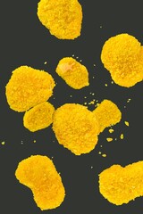 Falling nuggets isolated on a black background, selective focus. Fresh chicken nuggets falling on a...