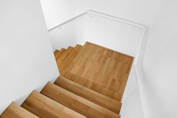 View of wooden stairs and railing in modern building