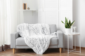 Interior of cozy living room with grey sofa and table
