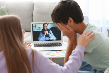 Upset little boy and his mother video chatting with psychologist at home