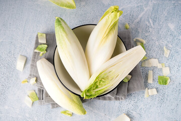 Bowl of fresh endive on light background