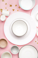 Different clean dishware on pink background