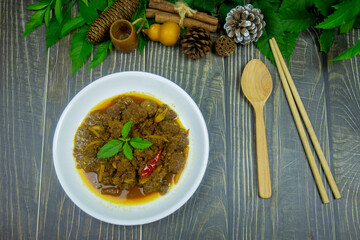 Lunch beef stewed ginger with chinese spices have taste is similar to massaman curry and serve on the dark wooden table.