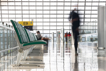 The corridor of the international airport with motion blur passengers