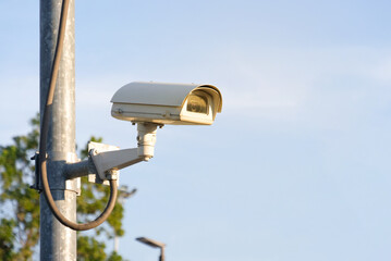 Modern public CCTV camera with clear sky background. Recording cameras for monitoring all day and night. Concept of surveillance and monitoring with copy space.