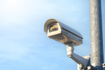 Modern public CCTV camera with clear sky background. Recording cameras for monitoring all day and night. Concept of surveillance and monitoring with copy space.