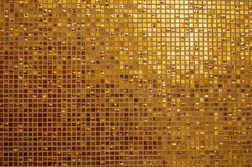 Small gold tile texture. Small golden tiles arranged to fit it into background. Shiny golden mosaic...