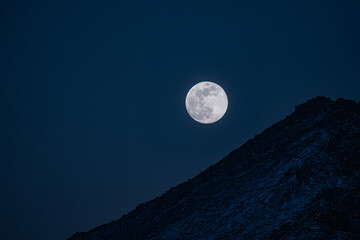 full moon over the mountains