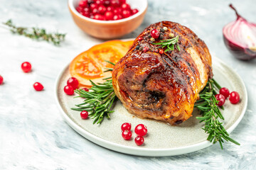 Roasted pork roll stuffed with cranberry berries on a light background. Restaurant menu, dieting, cookbook recipe top view