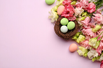 Composition with beautiful eustoma flowers and nest of Easter eggs on color background