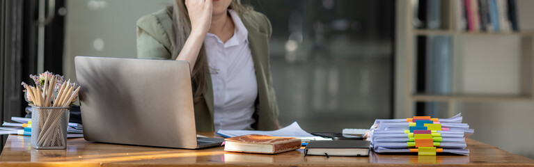 Asian businesswoman are stressed and tired from work sitting at desk in the office, feeling sick at...