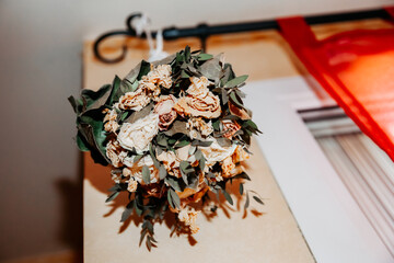 Dry wedding bouquet hanging on the window