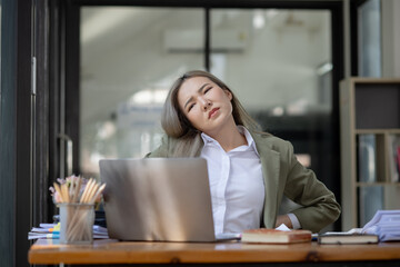 Fototapeta premium Asian businesswoman are stressed and tired from work sitting at desk in the office, feeling sick at work, stress from work. 