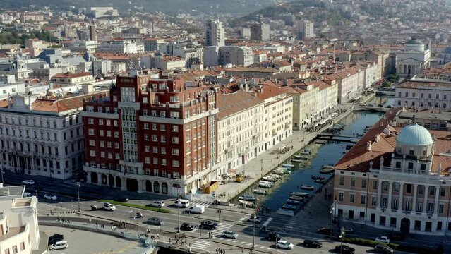 aerial drone shot of trieste city center from the sea on the canal grande ponterosso with hills in background