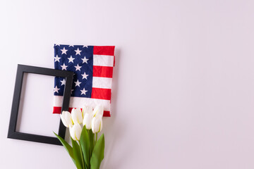 Happy presidents day concept with flag of the United States on white background with tulips for top...