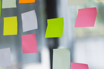 project plan using sticky papers notes on glass wall, people meeting to share idea, Business design...