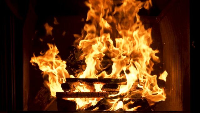 Beautiful shot of camp and fireplace fire burning in the dark at night.
