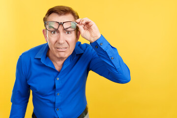 Mature man taking off her glasses to see