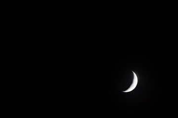 The growing moon with black copy space