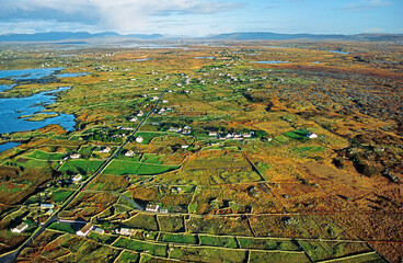 Typical Connemara landscape of rocky terrain, small marginal farms, tidal inlets and small lakes. County Galway, west Ireland. Aerial