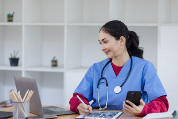 Happy smiling doctor woman working on laptop at desk in hospital, Professional doctor medical and healthcare.  