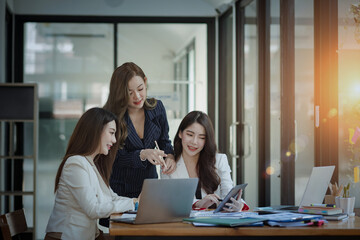 Fototapeta premium Technology and financial advisory services concert. Business teamwork and working on digital laptop computer with advisor showing plan of investment to clients at table office. Digital marketing.