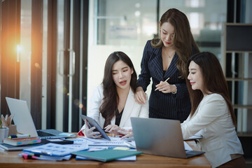 Group of young Asian business woman teamwork and presenting new projects in the office.