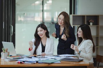 Group of young Asian business teamwork and presenting new projects in the office.