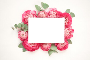 Layout for text placement. Space for text. Love letter. white card with white paper envelope mock up. Petals of flowers, roses and ranunculus. Valentine's day romantic background . 