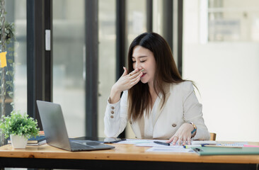 Asian businesswoman are stressed and tired from work sitting at desk in the office, feeling sick at work, stress from work.	