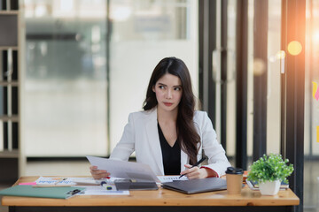 Asian businesswoman are stressed and tired from work sitting at desk in the office, feeling sick at work, stress from work.	