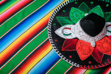 Mariachi hat with the colors of the Mexican flag on a colorful serape.