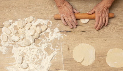 Rolling out the dough with your hands.