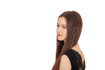 Fashionable teen cover girl model with long hair in black clothes posing at empty white isolated background, looking away. Pretty young lady shooting in studio. Modelling concept. Copy text space